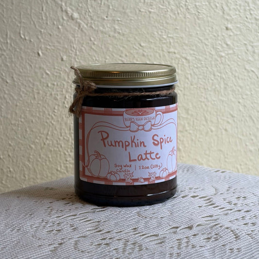 Pumpkin spice candle 7.2oz in an amber jar on a lace tablecoth
