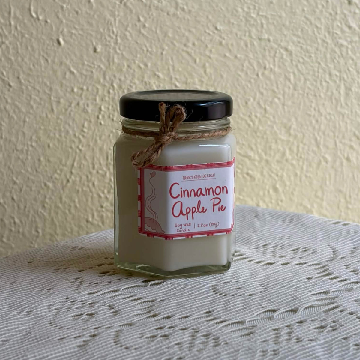 Cinnamon Apple Pie 2.8oz candle on a lace table cloth