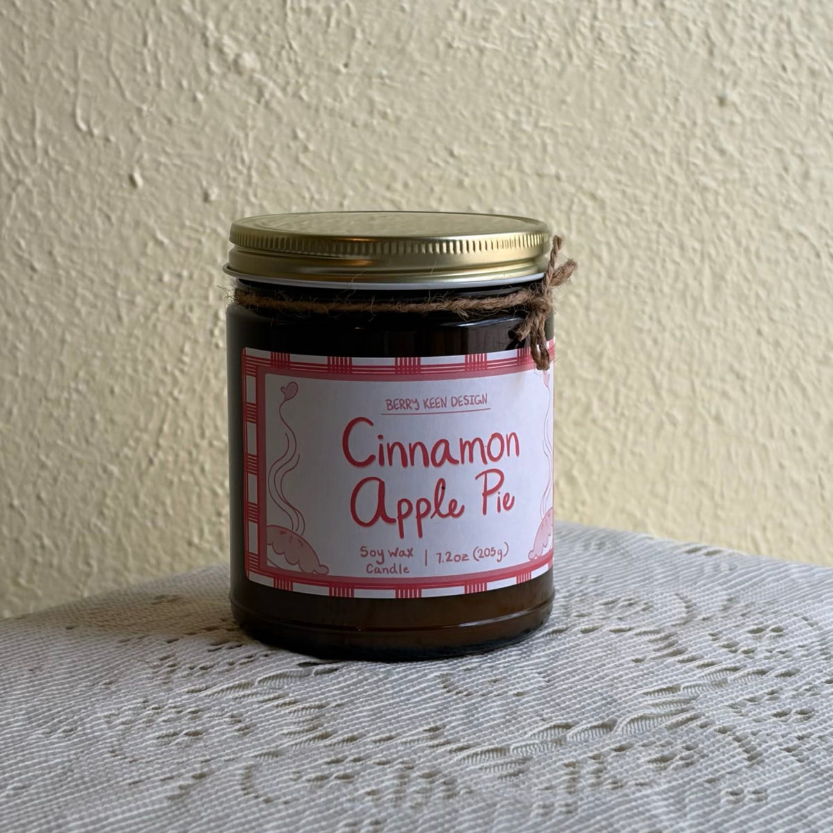 Cinnamon Apple Pie 7.2oz candle on a lace table cloth