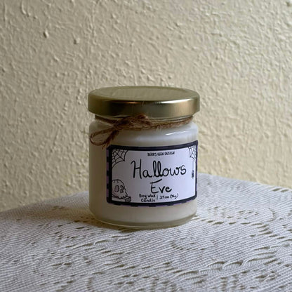 Hallows Eve 3.4oz candle on a lace table cloth