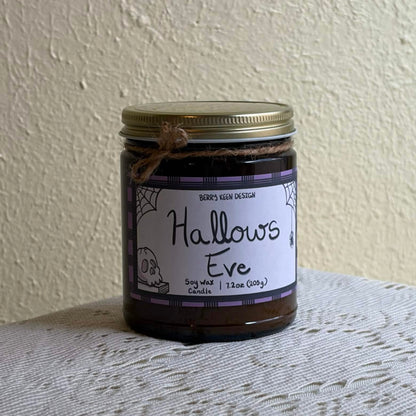Hallows Eve 7.2oz candle on a lace table cloth