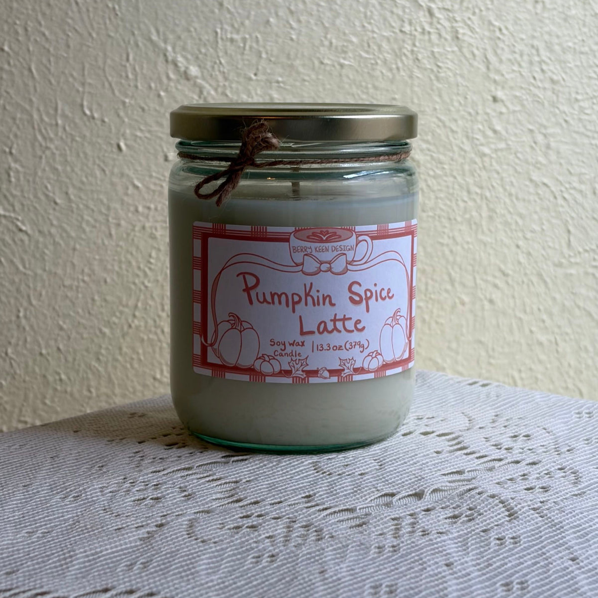Pumpkin spice candle 13.3oz on a lace tablecloth