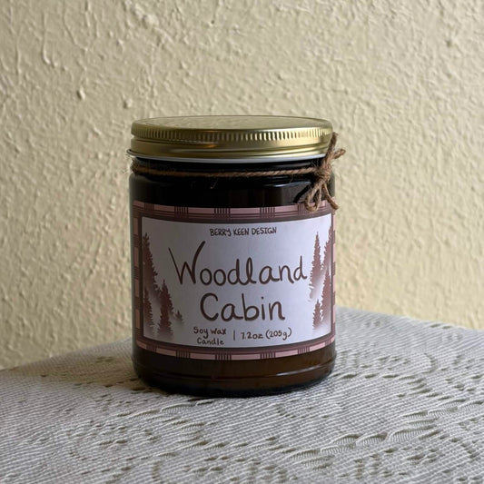 Woodland Cabin 7.2oz candle on a lace table cloth
